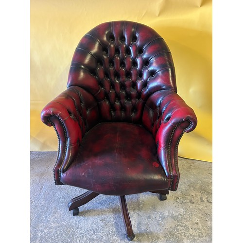 551 - Ox blood red Chesterfield style captains button-back leather chair.