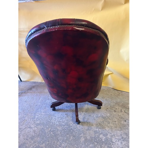 551 - Ox blood red Chesterfield style captains button-back leather chair.