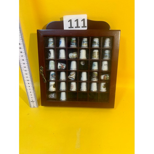 111 - Display case with thimble collection