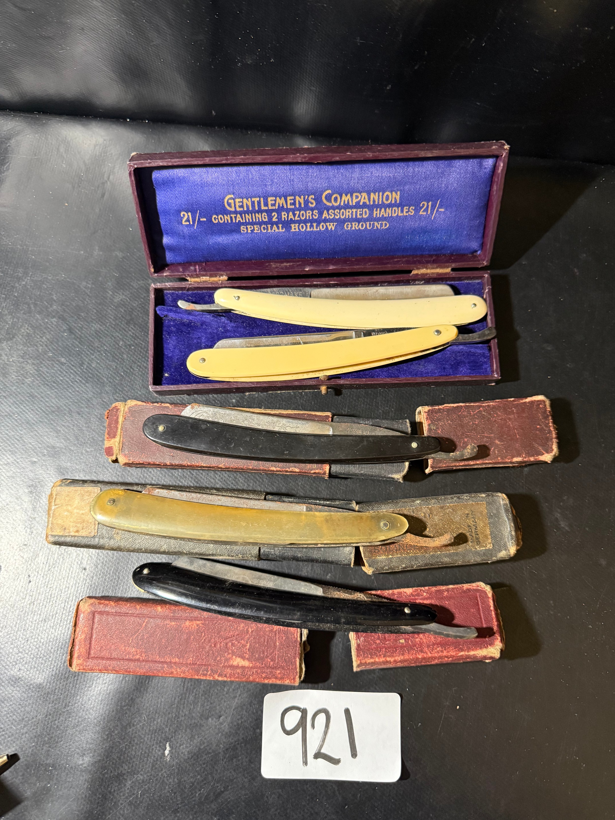 Collection of vintage cut throat razors in cases