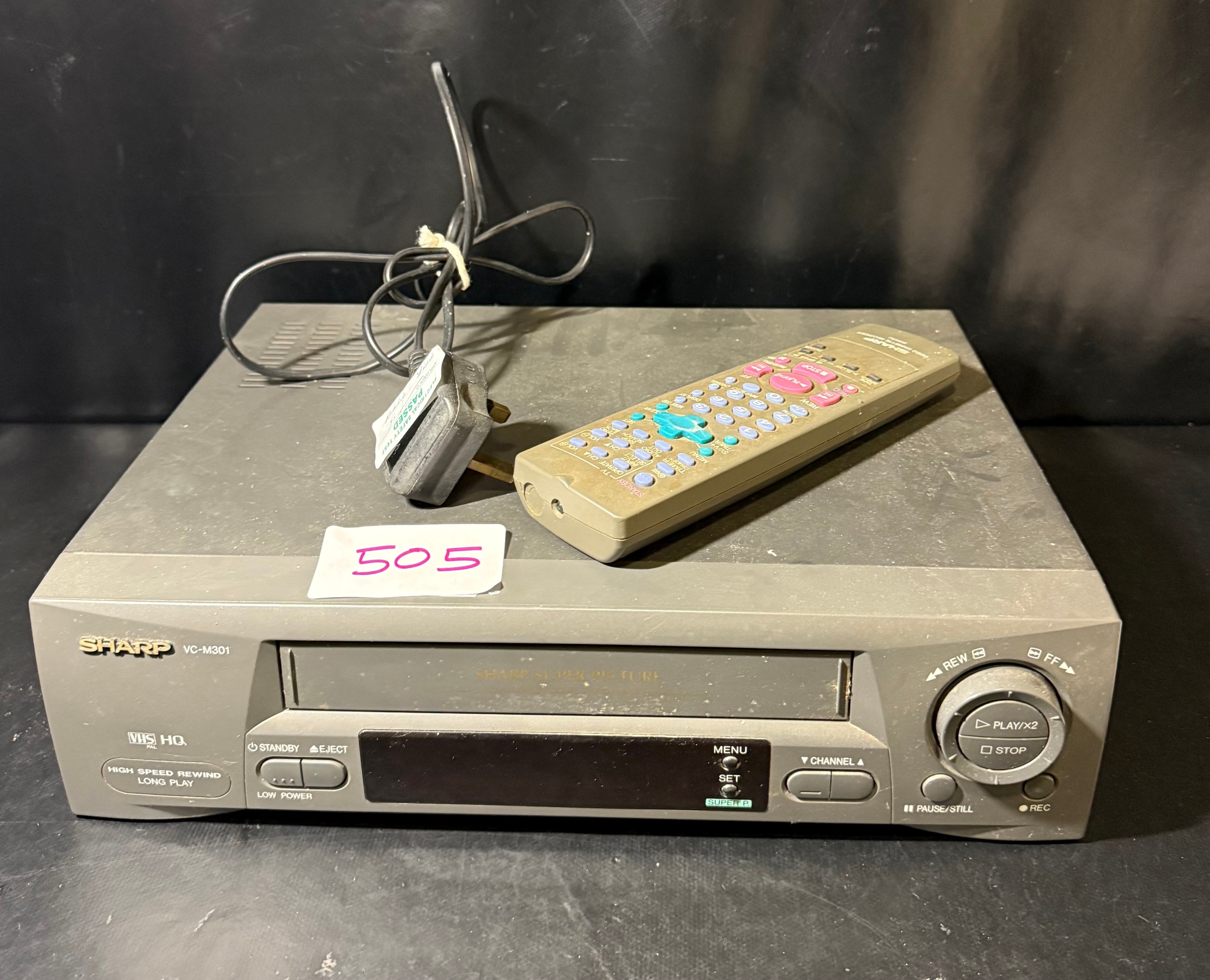 A Sharp VHS video cassette recorder, model VC-M301HM(GY), together with ...
