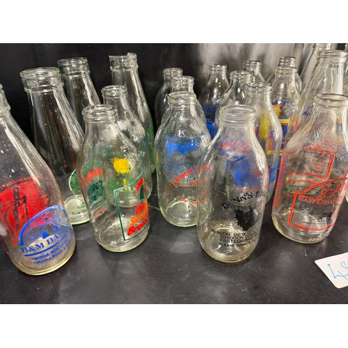 48 - Mixed group of vintage glass milk bottles with printed branding, including West Country dairies and ... 