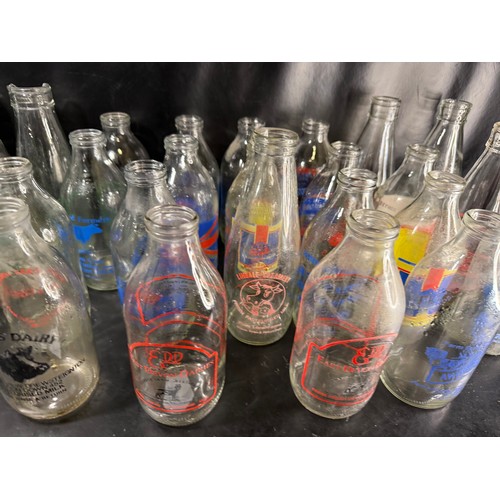 48 - Mixed group of vintage glass milk bottles with printed branding, including West Country dairies and ... 