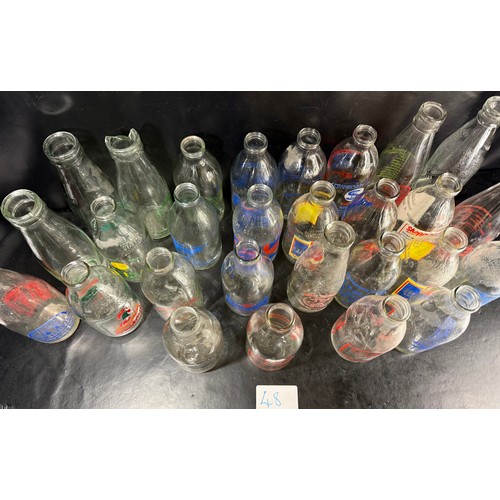 48 - Mixed group of vintage glass milk bottles with printed branding, including West Country dairies and ... 