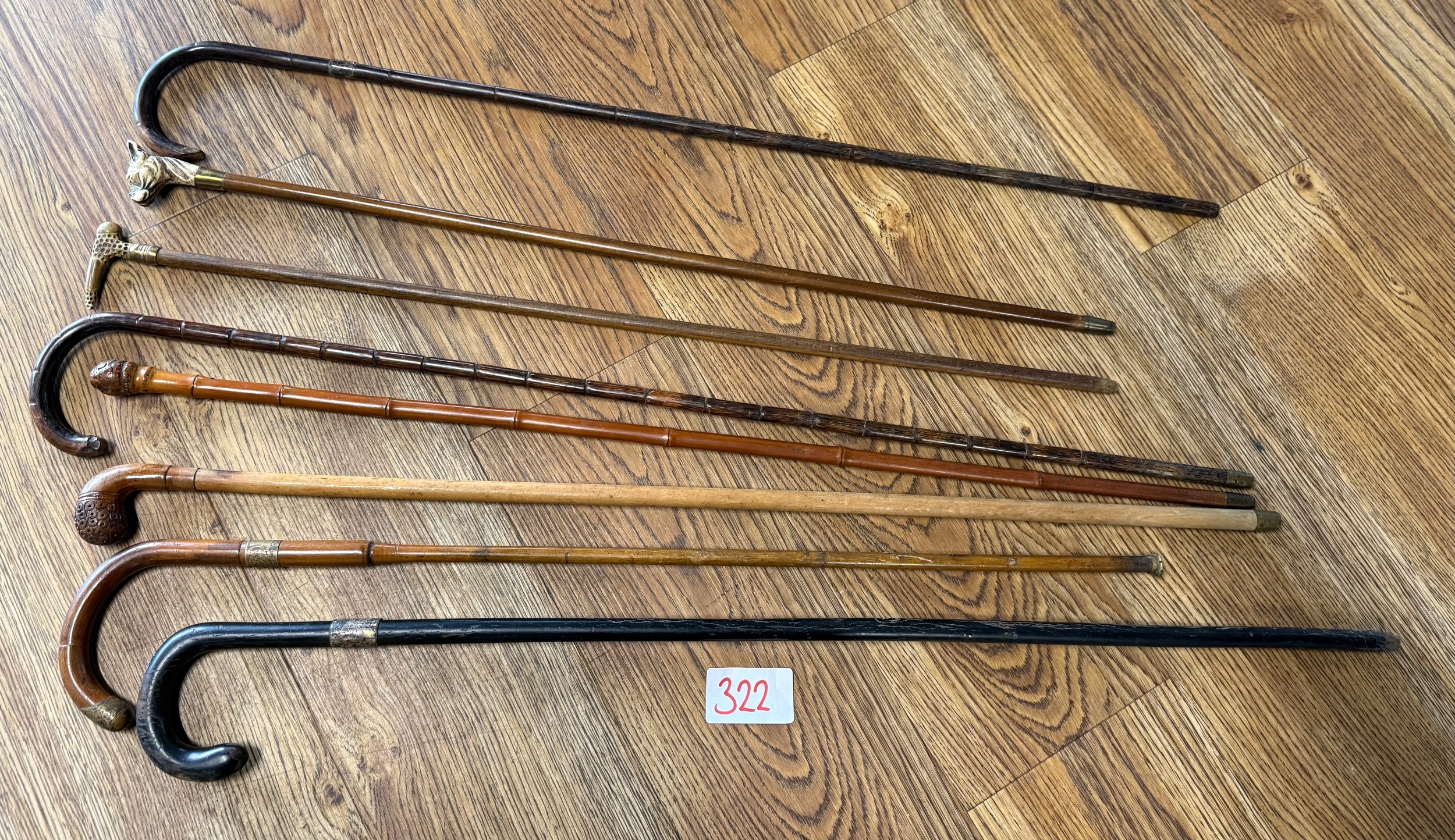 A collection of vintage walking sticks and canes including bamboo and ...
