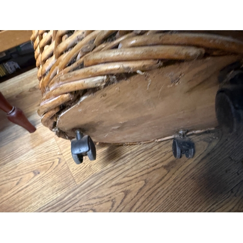 69 - Large wicker log / laundry basket on castors