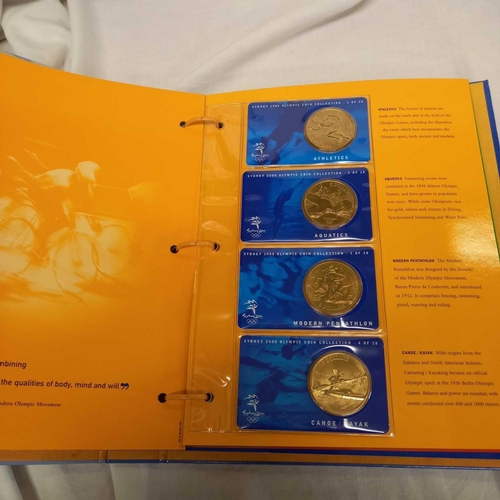 715 - FOLDER OF 28 BRONZE COINS COMMEMORATING THE SYDNEY 2000 OLYMPIC GAMES BY AUSTRALIAN MINT, CAMBRA & P... 