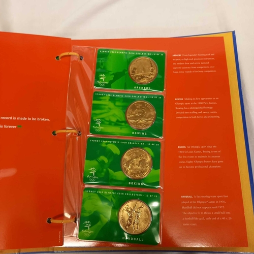 715 - FOLDER OF 28 BRONZE COINS COMMEMORATING THE SYDNEY 2000 OLYMPIC GAMES BY AUSTRALIAN MINT, CAMBRA & P... 