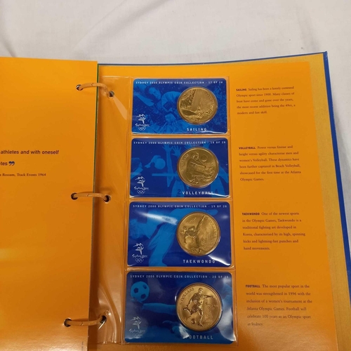 715 - FOLDER OF 28 BRONZE COINS COMMEMORATING THE SYDNEY 2000 OLYMPIC GAMES BY AUSTRALIAN MINT, CAMBRA & P... 