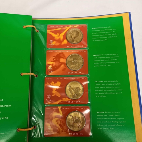 715 - FOLDER OF 28 BRONZE COINS COMMEMORATING THE SYDNEY 2000 OLYMPIC GAMES BY AUSTRALIAN MINT, CAMBRA & P... 