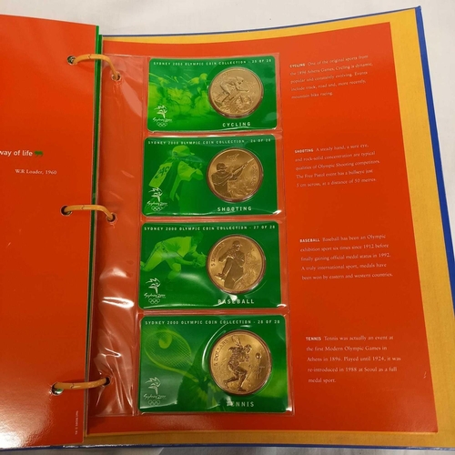 715 - FOLDER OF 28 BRONZE COINS COMMEMORATING THE SYDNEY 2000 OLYMPIC GAMES BY AUSTRALIAN MINT, CAMBRA & P... 