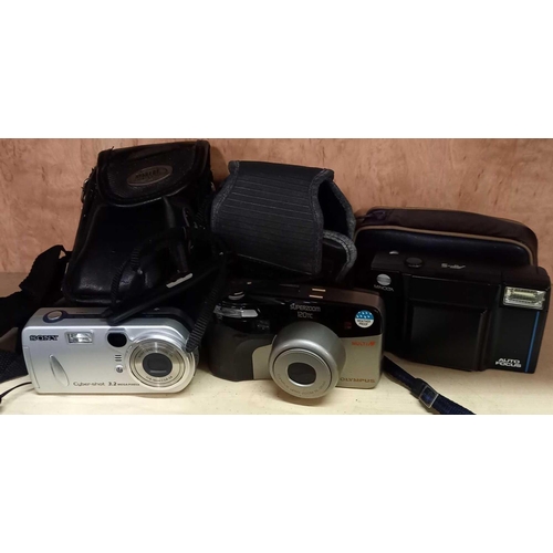 843 - 3 CASED CAMERA, SONY CYBER SHOT 3.2 MEGA PIX WITH MINI TRIPOD, AN OLYMPUS SUPER ZOOM 120 TC & MINOLT... 