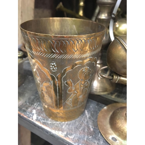 32 - PART SHELF OF BRASS WARE INCLUDING A HANGING PARAFFIN LAMP