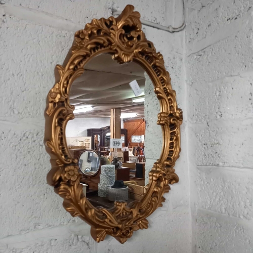 379 - ORNATE GILT FRAMED OVAL MIRROR