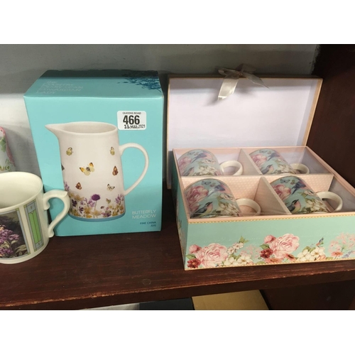 466 - SHELF OF DECORATIVE CERAMIC MUGS & A VASE