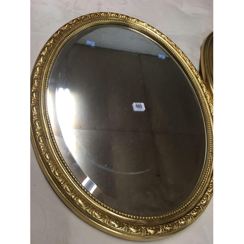 489 - PAIR OF GILT FRAMED OVAL BEVELLED EDGE MIRRORS