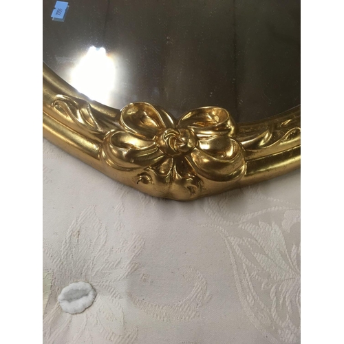 489 - PAIR OF GILT FRAMED OVAL BEVELLED EDGE MIRRORS