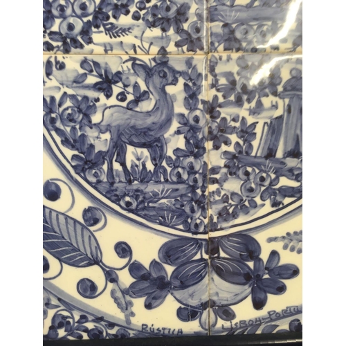 518 - A FRAMED SET OF 4 BLUE AND WHITE DELFT STYLE TILES IN ONE FRAME