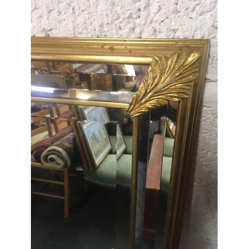 608 - GILT FRAMED BEVELLED EDGE WALL MIRROR (MISSING A GOLD COLOURED LEAF)