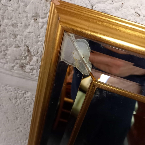 608 - GILT FRAMED BEVELLED EDGE WALL MIRROR (MISSING A GOLD COLOURED LEAF)