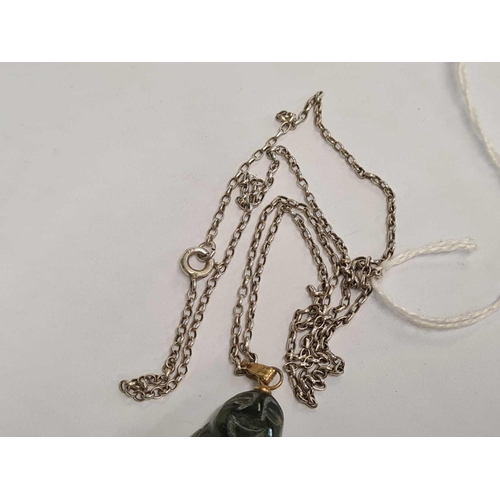 743 - A CARVED GREEN STONE BUDDHA ON A SILVER NECK CHAIN 21'' LONG