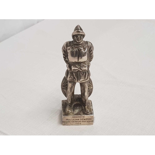 766 - WHITE METAL FIGURE OF A LIFE BOAT MAN BEING AN AWARD TO MISS LILIAN DOWZER FOR WORK FOR THE LIFE BOA... 