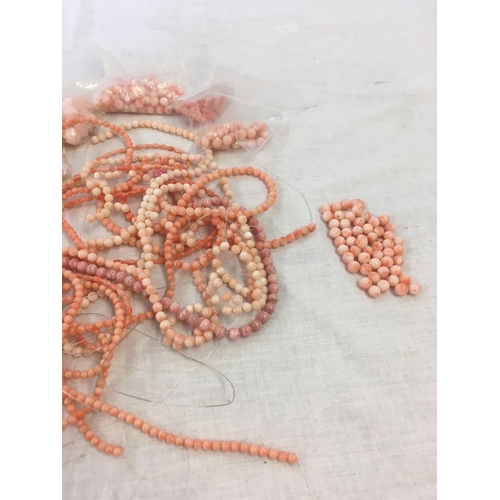 807 - SMALL CARDBOARD BOX OF CORAL BEADS, NECKLACES ETC