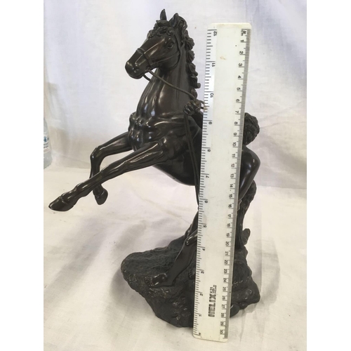 842 - RESIN FIGURE OF A MALE HOLDING A REARING HORSE