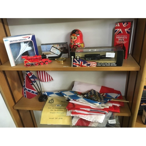 887 - 2 SHELVES OF MISC ITEMS INCL; A BOXED MODEL OF THE SUPER SONIC THRUST CAR, BRITISH AIRWAYS CONCORDE,... 