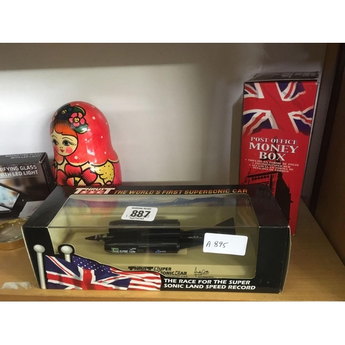 887 - 2 SHELVES OF MISC ITEMS INCL; A BOXED MODEL OF THE SUPER SONIC THRUST CAR, BRITISH AIRWAYS CONCORDE,... 