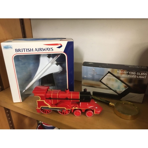 887 - 2 SHELVES OF MISC ITEMS INCL; A BOXED MODEL OF THE SUPER SONIC THRUST CAR, BRITISH AIRWAYS CONCORDE,... 