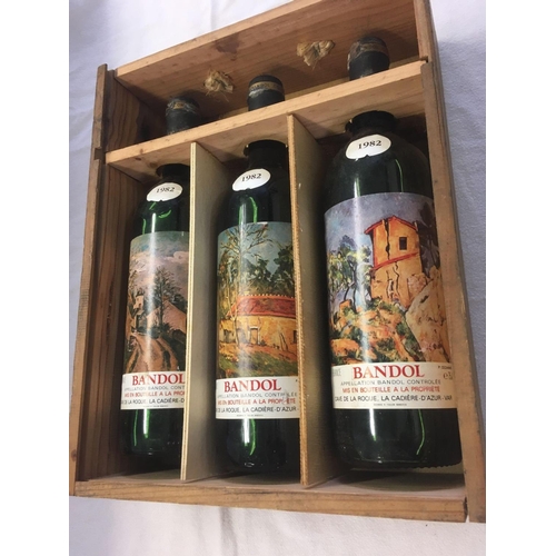 927 - WOOD CASE WITH 3 BOTTLES OF 1982 BANDOL WINE, 2 ULLAGED MID TO LOW SHOULDER