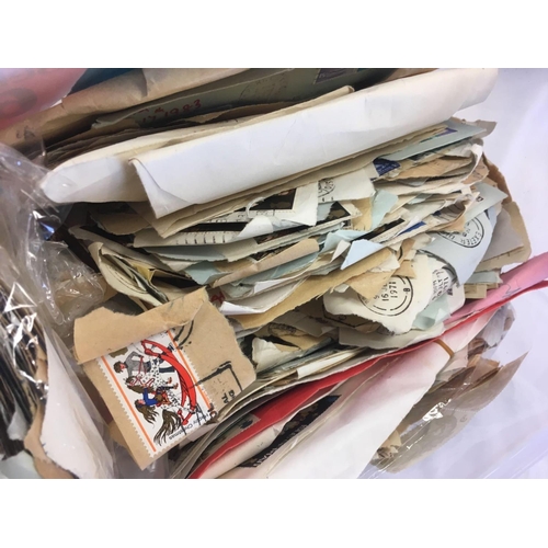 928 - TUB OF MISC USED POSTAGE STAMPS & POSTCARDS