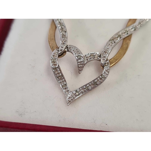 665 - A DIAMOND 2 COLOUR 9ct HEART SHAPED PENDANT ON NECK CHAIN