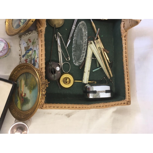 839 - SMALL CANE BASKET WITH MISC METALWARE, HORN COMB, CHINA PIN DISHES, CALLIGRAPHY PEN & 2 GILT FRAMED ... 