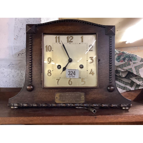 324 - ART DECO CARVED OAK CHIMING MANTLE CLOCK WITH BRASS PLAQUE