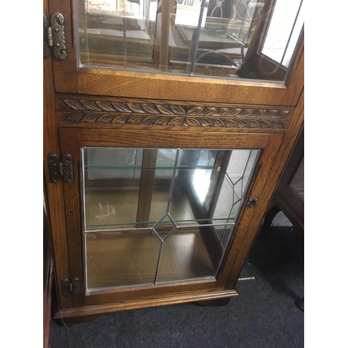 468 - TALL NARROW OAK DISPLAY CABINET BY OLD CHARM WITH LEADED GLASS DOORS