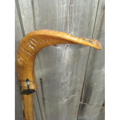 380 - WOODEN HIKING STICK WITH HORN HANDLE & QTY OF TOWN BADGES ATTACHED