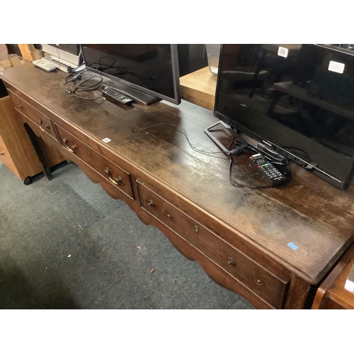 309 - ANTIQUE OAK SIDEBOARD WITH 3 DRAWERS & BRASS DROP HANDLES, 3 HANDLES MISSING. 7ft WIDE