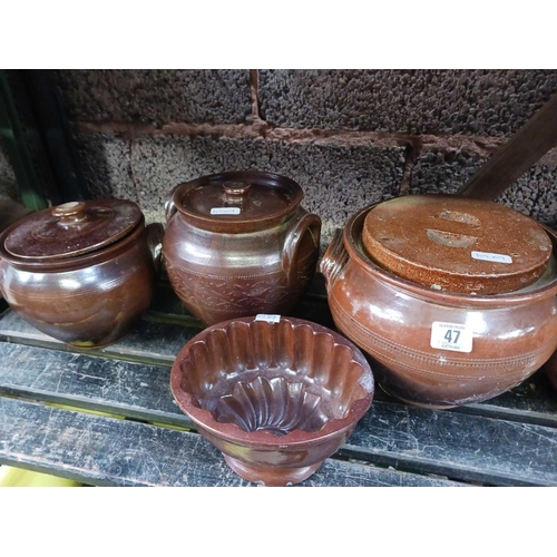 47 - SHELF OF LIDDED EARTHENWARE & A JELLY MOULD