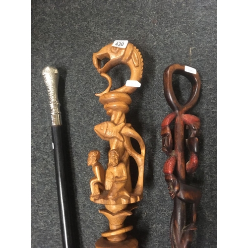 430 - 2 ETHNIC CARVED WALKING STICKS & A WALKING CANE