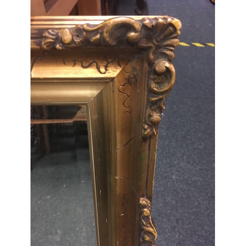 497 - GOLD COLOURED GILT FRAMED BEVELLED EDGE MIRROR