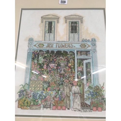 559 - FRAME CONTAINING 3 NEEDLEWORK PICTURES OF SHOP FRONTS, 2 INDISTINCTLY SIGNED, 23'' X 44''