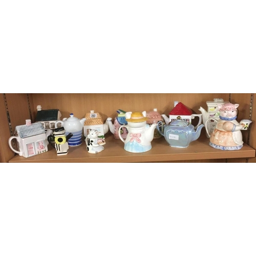 283 - SHELF OF NOVELTY TEA POTS