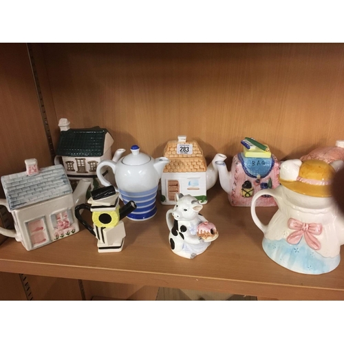 283 - SHELF OF NOVELTY TEA POTS