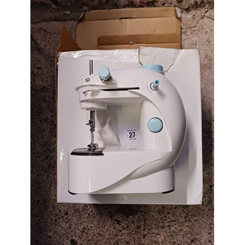 27 - BATTERY POWERED SEWING MACHINE, NOT KNOW IF COMPLETE