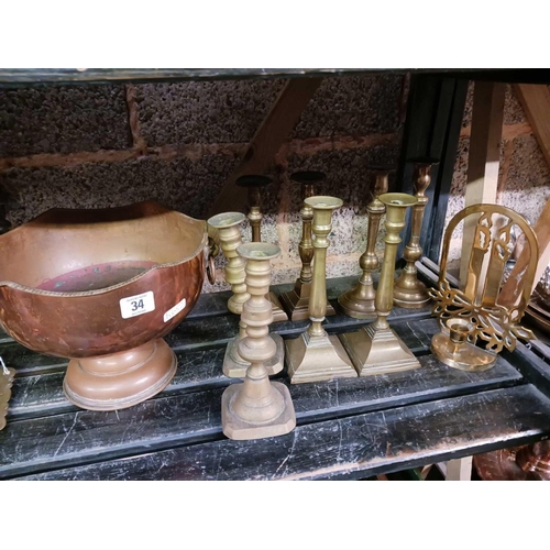 34 - SHELF OF MISC BRASS WARE INCL; CANDLESTICKS, POT STAND & A COPPER MONTEITH