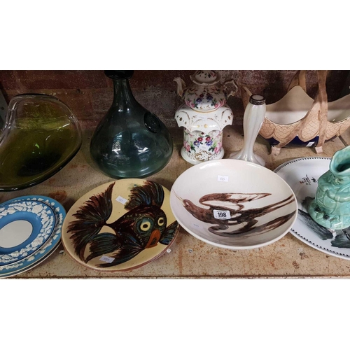 198 - SHELF WITH MISC DECORATIVE GLASS & PLATES & A GLASS SHIP'S DECANTER STYLE BOTTLE MARKED CE