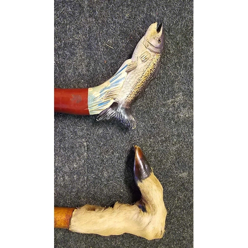 468 - 2 WALKING STICKS, 1 WITH A FISH HANDLE & 1 WITH A HOOF HANDLE