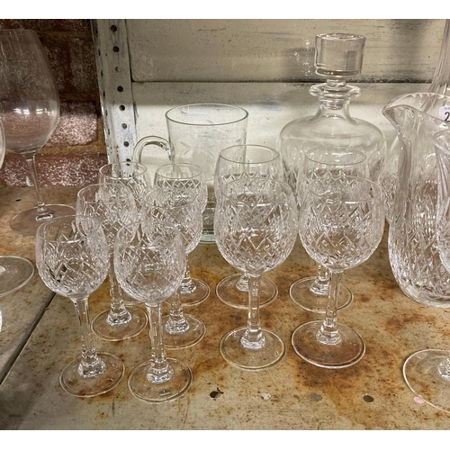 225 - SHELF OF CUT GLASS WINE GLASSES, GOBLETS, WATER JUG, DECANTERS ETC